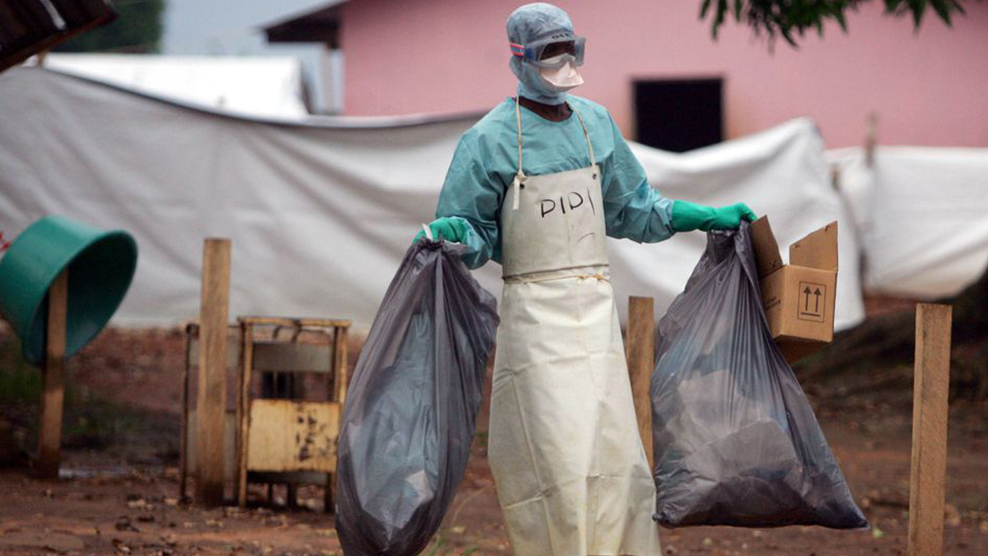 A health worker in protective clothing carries waste for disposal outside the isolation ward where victims of the deadly Marburg virus are treated in the northern Angolan town of Uige, File. - Photo Credit: Reuters