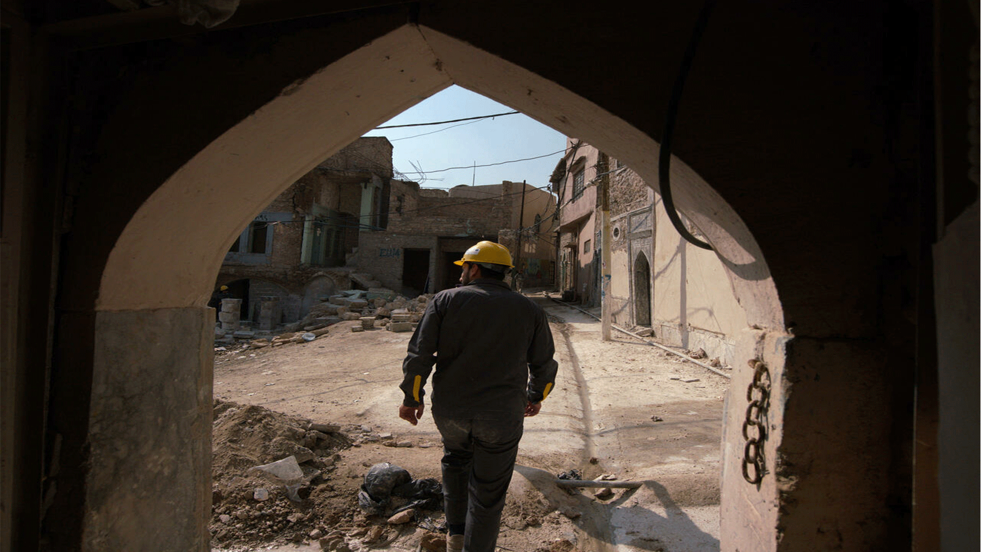 An Iraqi architect exits a traditional house during renovations in the Old Town of Mosul, which was reduced to rubble during fighting to expel jihadists Zaid AL-OBEIDI AFP