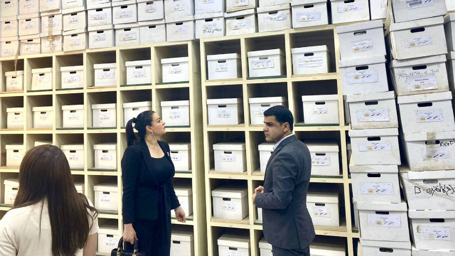  MPs Karwan Yarwais and Suzan Mansour looking at the boxes which contain the remains of the Anfal victims.