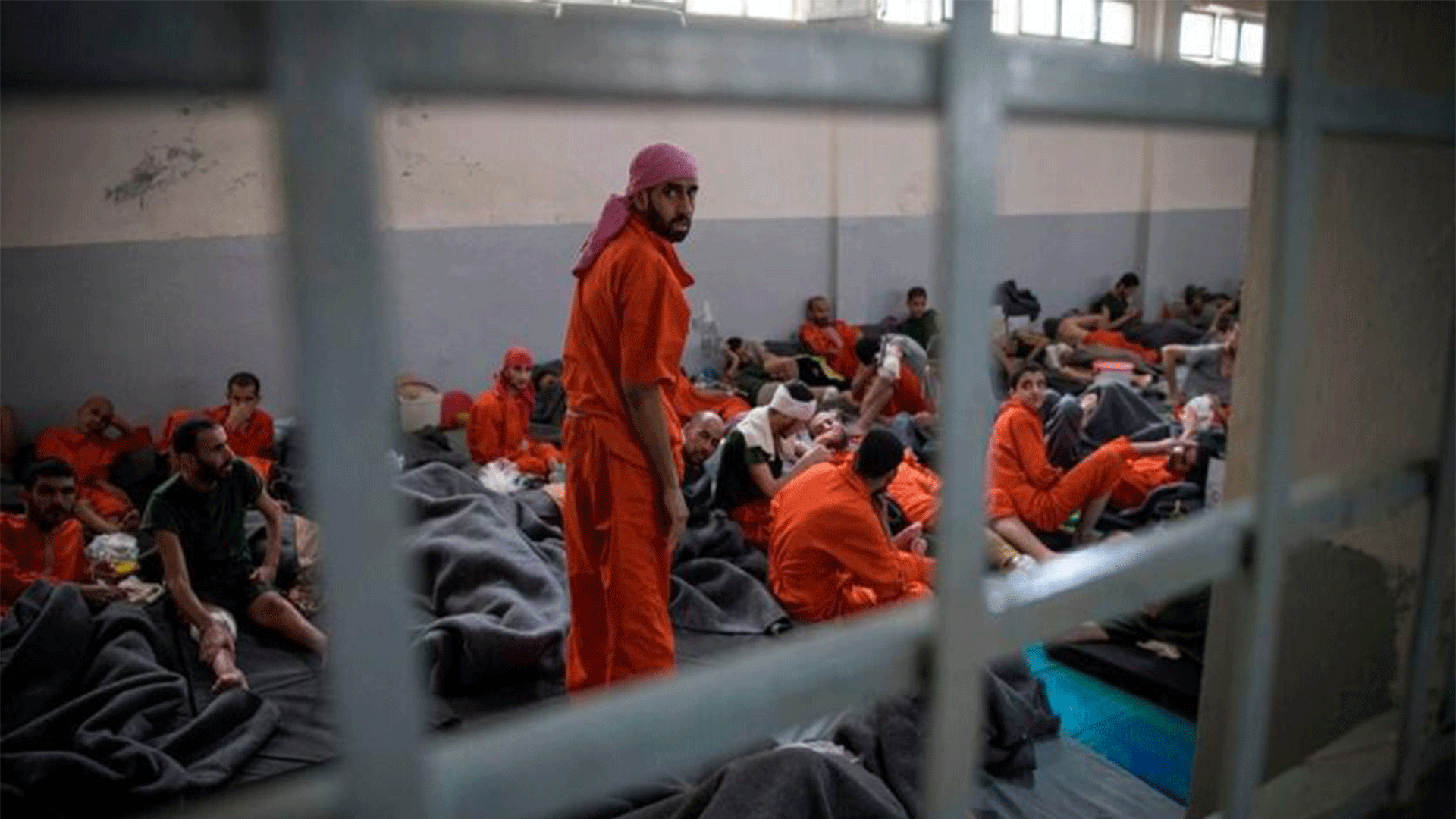  Men allegedly affiliated with the ISIS group sit on the floor in a prison in the northeastern Syrian city of al-Hasaka on Oct. 26, 2019. (Getty Images)