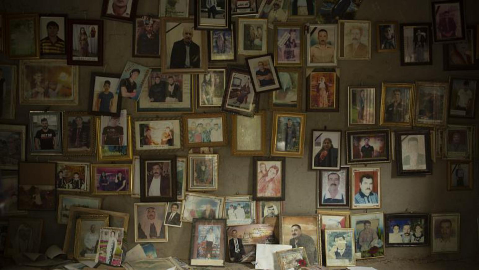  In this Sept. 12, 2019 photo, pictures of Yazidis slain in 2014 by Islamic State militants are found in a small room at the Lalish shrine in northern Iraq . (Maya Alleruzzo/ The Associated Press)